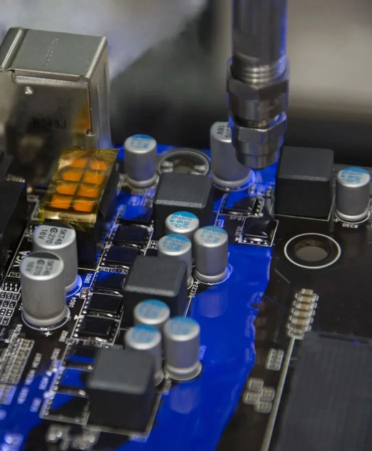 Selective dispensing nozzle over components on an assembled circuit board